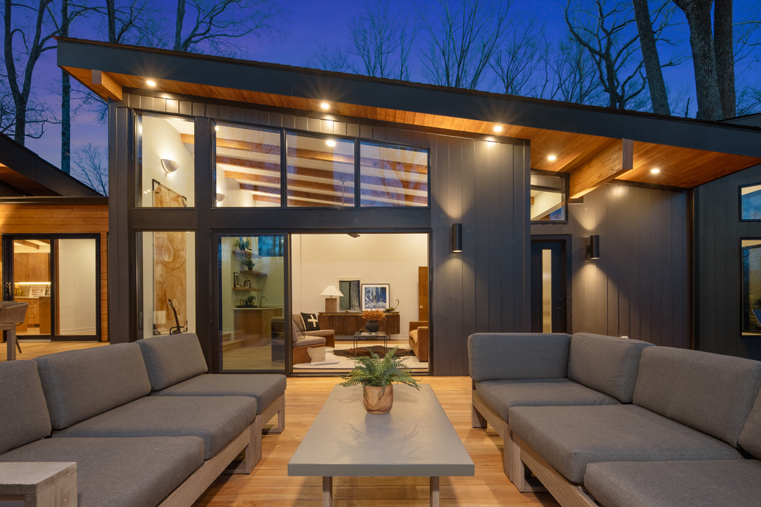 Illuminated rear elevation and deck at dusk