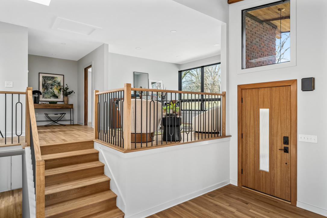 Renewed split-level entry with oak and custom metalwork