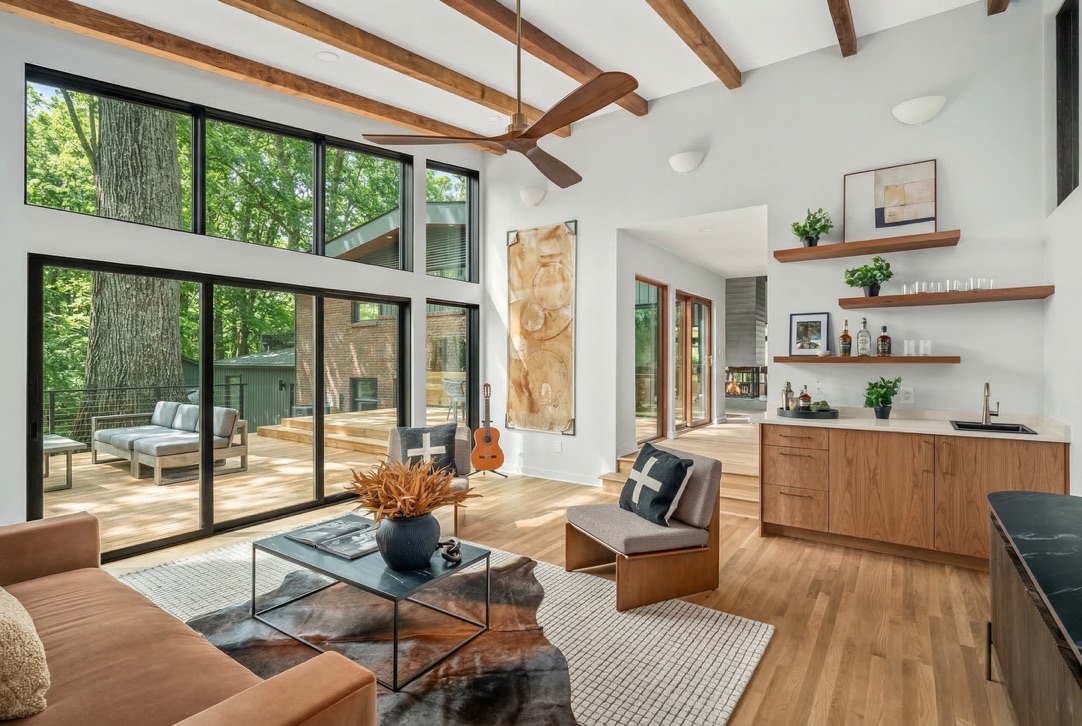 Living room with full-height glazing and exposed wood beams